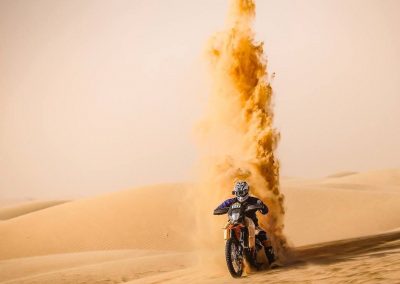 Moto in the desert throwing sand