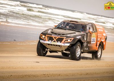 Car on beach racing rally to Dakar